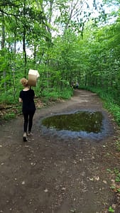 Olivia carrying the landmarks 2017 sculpture to its next exhibit location in Rouge National Park