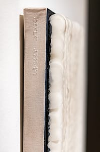 A side view of Scales, revealing a Braille signature of the artist's name.