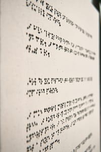 A detail of a canvas with Braille painted in paragraphs.