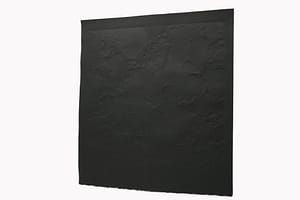 A black square paper is embossed with textures of organic shapes.