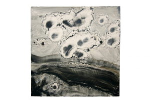 A square panel with a dark landscape-like view covering the bottom half and dark circles scattered on the top half. All dark areas are covered with cold wax.