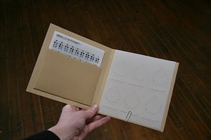 A close up of the CONTACT kit booklet opened.