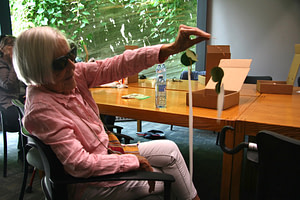 A participant is holding up their completed mobile sculpture.
