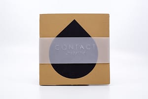 Image description: A small, square book cover with a black teardrop shape in the centre, and a thin translucent slip with "CONTACT" in English text and Braille embossed on the front.